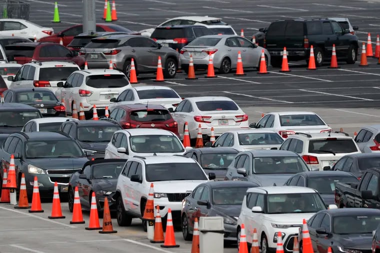 In Florida, which reopened early with few precautions against the coronavirus, more than 200,000 people have tested positive. Lines of cars waited at a drive-through coronavirus testing site on July 5 outside Hard Rock Stadium in Miami Gardens. (AP Photo/Wilfredo Lee)