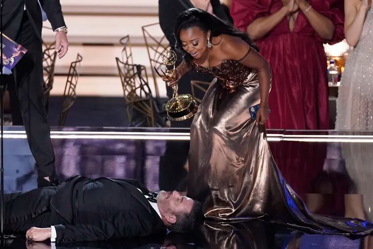 Quinta Brunson (right), winner of the Emmy for outstanding writing for a comedy series for "Abbott Elementary," checked on Jimmy Kimmel as he lay on stage at the 74th Primetime Emmy Awards on Monday at the Microsoft Theater in Los Angeles.