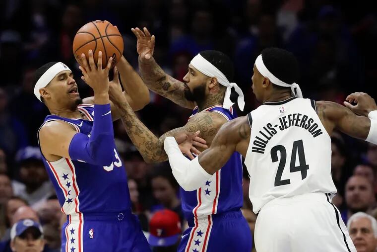 Sixers forward Tobias Harris (left) and forward Mike Scott grab the basketball past Brooklyn Nets forward Rondae Hollis-Jefferson during the third-quarter in game two of the Eastern Conference playoffs on Monday, April 15, 2019 in Philadelphia.
