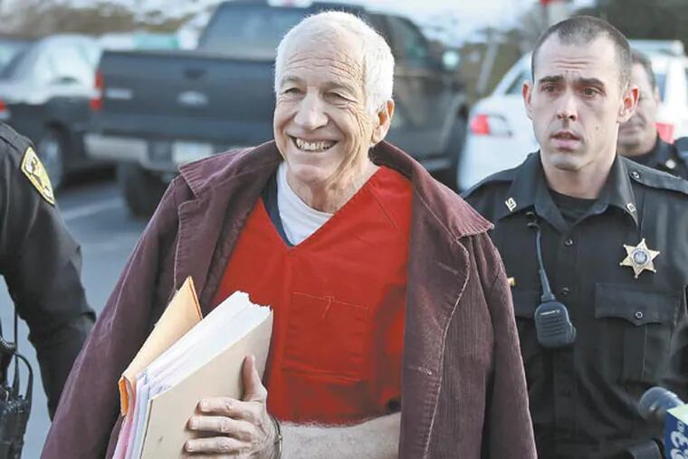 Former Penn State University assistant football coach Jerry Sandusky, center, arrives at the Centre County Courthouse for a post-sentence motion in Bellefonte, Pa., Thursday, Jan. 10, 2013. Thursday's hearing in Bellefonte is expected to delve into the legal challenges filed by Sandusky's lawyers, including their claim that a deluge of prosecution materials swamped the defense. Sandusky is serving a 30- to 60-year prison sentence after being convicted in June of 45 counts of child sexual abuse. (AP Photo/Gene J. Puskar)