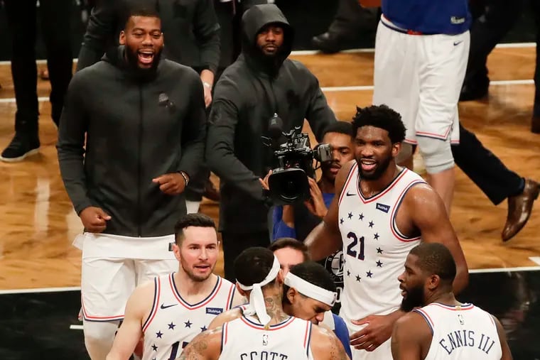 Sixers forward Mike Scott celebrates with his teammate after the Sixers beat the Brooklyn Nets in game four of the Eastern Conference playoffs on Saturday, April 20, 2019 in Brooklyn.