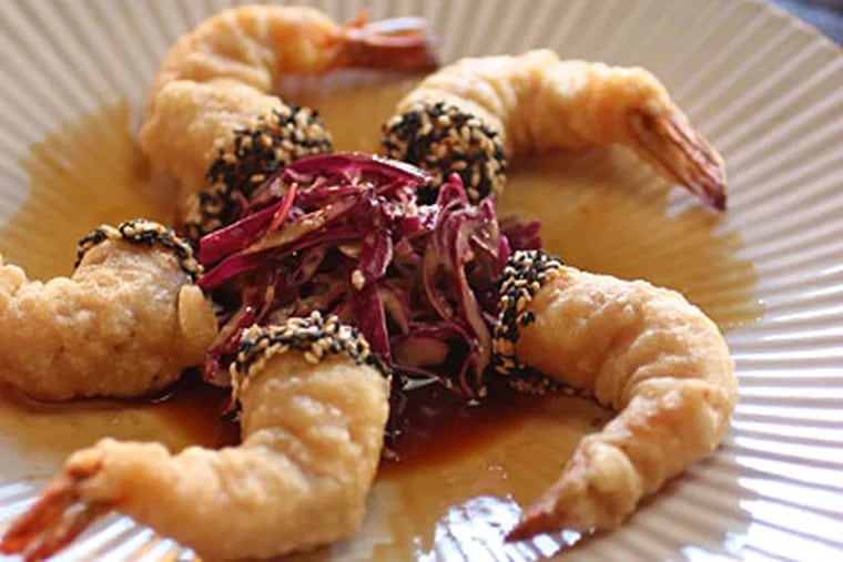 Mexican wild shrimp are deftly fried in an airy tempura batter speckled with sesame seeds, and streaked with orange gastrique. (MICHAEL BRYANT / Staff Photographer)