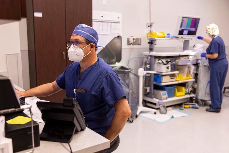 Steven Fassler, 52, Colorectal Surgeon at Huntingdon Valley Surgery Center, goes over his notes after seeing a patient  in Huntingdon Valley, Pa., on Wednesday, July 28, 2021.