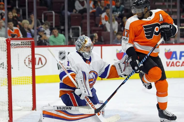 New York Islanders goalie Thomas Greiss defends as the Philadelphia Flyers’ Waynes Simmonds attempts to screen a shot on goal during the second period.