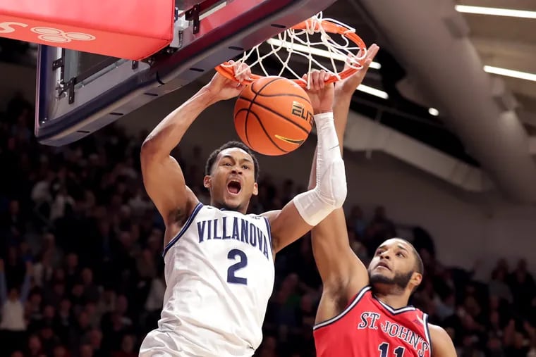 Mark Armstrong (left) of Villanova goes up for a dunk against Joel Soriano of St. John's during the 2nd half of their game on Dec.21, 2022 at the Finneran Pavilion at Villanova University.