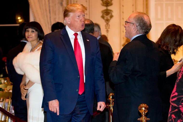 President Donald Trump speaks to attorney Alan Dershowitz, right, as he arrives for Christmas Eve dinner at Mar-a-lago in Palm Beach, Fla., Tuesday, Dec. 24, 2019.