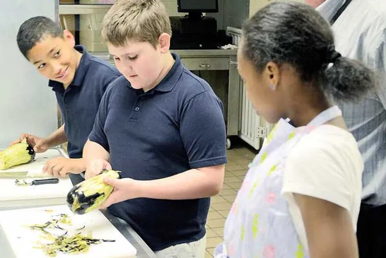 Henry Lawton School fifth-grade students (back to front) Nicholas Rodriguez, Christian McKinney, and Nysirah Hall cut vegetables for ratatouille. ( TOM GRALISH / Staff Photographer