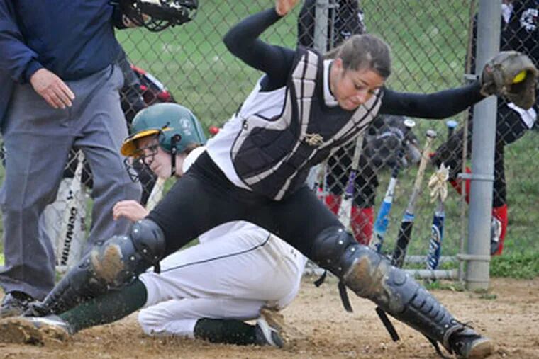 Archbishop Caroll catcher Kerri Hunt hangs on to the ball for a force out on Lansdale Catholic's  Alicia Kradzinski. (Ron Tarver/ Staff Photographer)