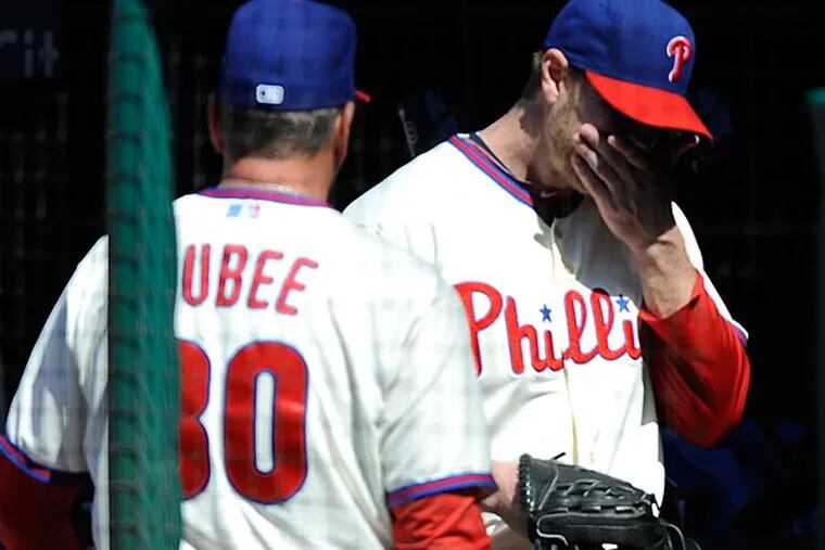 Philadelphia Phillies' Roy Halladay, right, walks past Rick Dubee
after being taken out in the third inning of a baseball game on
Sunday, May 5, 2013, in Philadelphia. (AP Photo/Michael Perez)