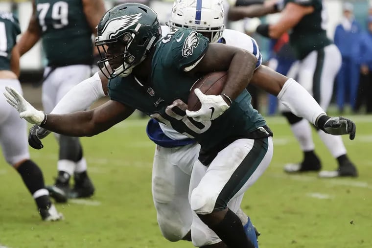 Eagles running back Wendell Smallwood runs with the football against Indianapolis Colts defensive end Al-Quadin Muhammad on Sunday, September 23, 2018 in Philadelphia. YONG KIM / Staff Photographer