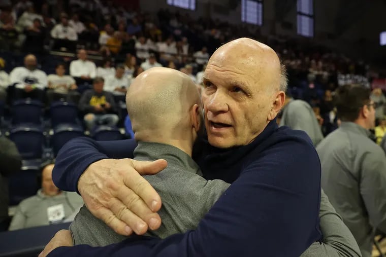 Phil Martelli (right) gives his son, Jimmy, a hug before Penn State played Michigan on Jan. 7 at the Palestra.