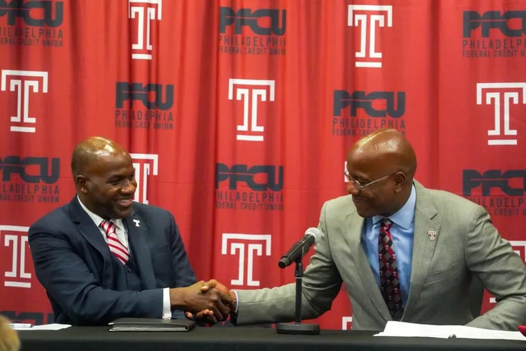 Athletic director Arthur Johnson, left, and Temple University President Jason Wingard shake hands at a Liacouras Center for a press conference to welcome Johnson to Temple, October 7, 2021.