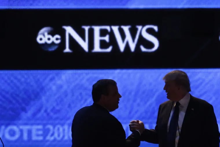 At a Republican presidential primary debate hosted by ABC News in February 2016, Donald Trump and Chris Christie speak during a break.