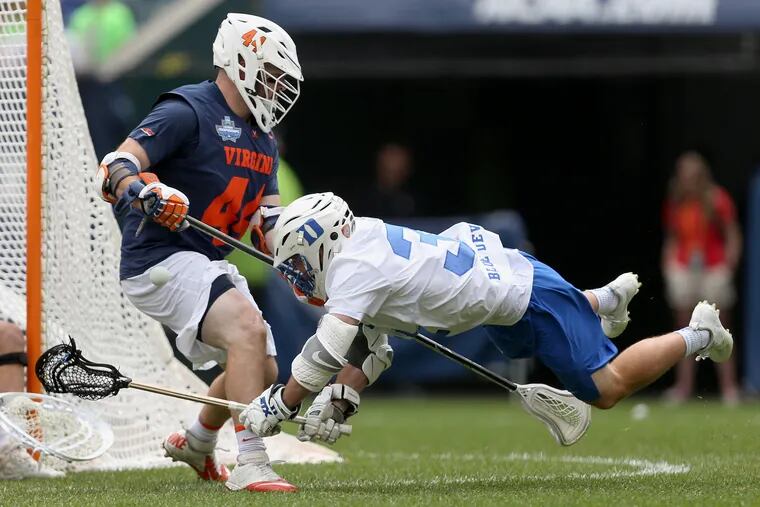 Duke's Joey Manown (31) attempts a shot around Virginia's Logan Greco (44) during their NCAA men's Division I lacrosse semifinal game at Lincoln Financial Field in South Philadelphia on Saturday, May 25, 2019.