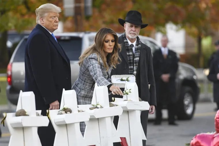 President Donald Trump and first lady Melania lay stones at a memorial for victims of the massacre at Tree of Life synagogue, Tuesday, Oct. 30, 2018, in Squirrel Hill. At right is Rabbi Jeffrey Myers, who survived the shooting.
