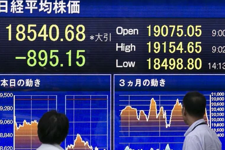 Electronic board showing the Nikkei Stock Average in Tokyo, affected by worldwide woes earlier this week.