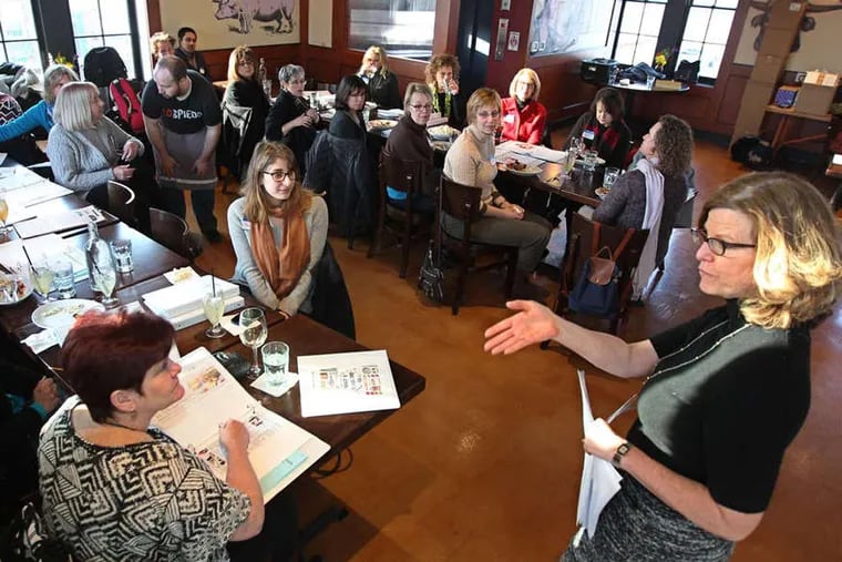 Inquirer food editor Maureen Fitzgerald (right) talks to the volunteers for My Daughter's Kitchen cooking classes. They gathered at Lo Spiedo at the Navy Yard to prep for this year's session of cooking classes. ( Michael Bryant / Staff Photographer )