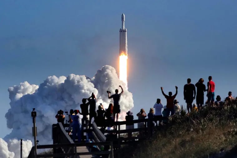 The crowd cheers at Playalinda Beach in the Canaveral National Seashore, just north of the Kennedy Space Center, during the succesful launch of the SpaceX Falcon Heavy rocket. Playalinda is one of the closest public viewing spots to see the launch, about 3 miles from the SpaceX launchpad 39A.