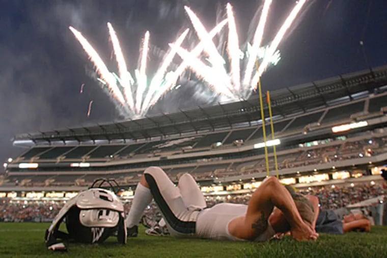 Kicker David Akers watches the fireworks during the Eagles' Flight Night. (April Saul / Staff Photographer)