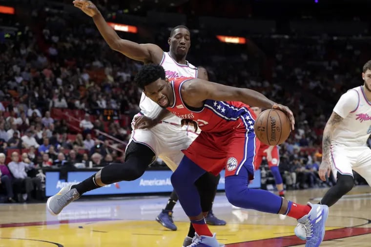 Sixers center Joel Embiid (right) drives as Miami forward Bam Adebayo defends during the Sixers’ loss on Thursday.
