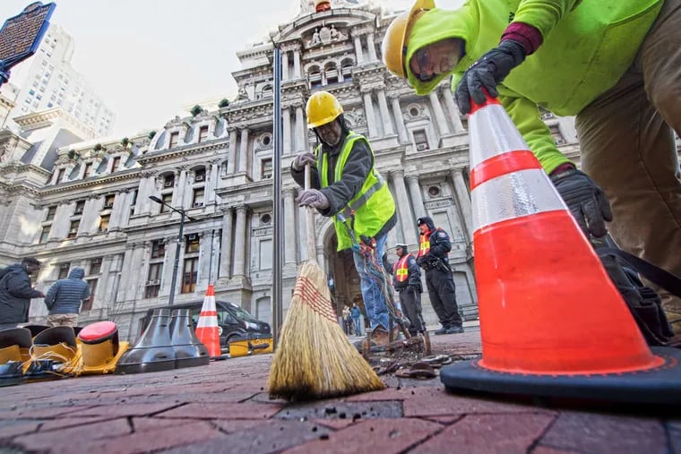 City workers clean up and replace traffic lights taken down outside City Hall in Center City, Philadelphia, Feb. 5, 2018. Fans took the celebration too far causing damage in parts of the city, after an Eagles win over the New England Patriots in the Super Bowl.
