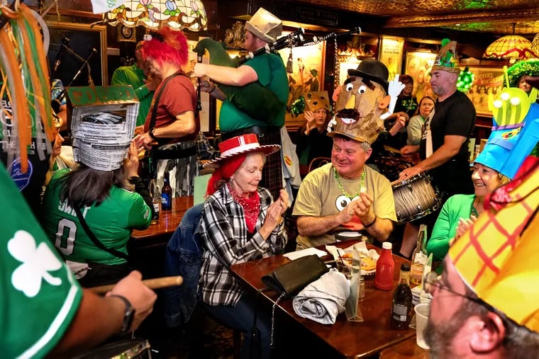 Mary Boggi (left, as Jessie the cowgirl rag doll) and Marc Travaglione (right, with a Mr. Potato Head bag) join friends from Cumberland County with a Toy Story theme, celebrating Bag Day at the Irish Pub in Atlantic City on Monday. The tradition got started when a late-to-the-party patron showed up to the 24-hour bar a day after St. Patrick's, then put a bag on their head.