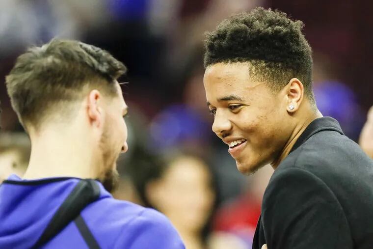 Injured Sixers guard Markelle Fultz  (right) has not played since October.