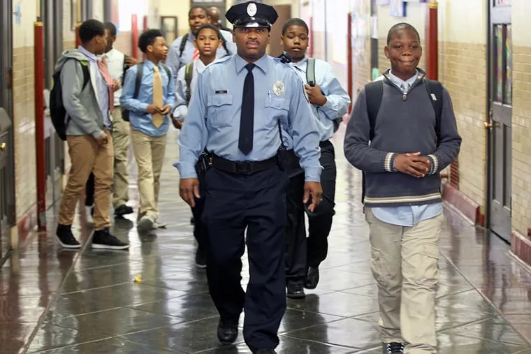 School Police Officer Donald Lewis and his Men of Mitchell walk to a first-grade class at Mitchell Elementary in Southwest Philadelphia.