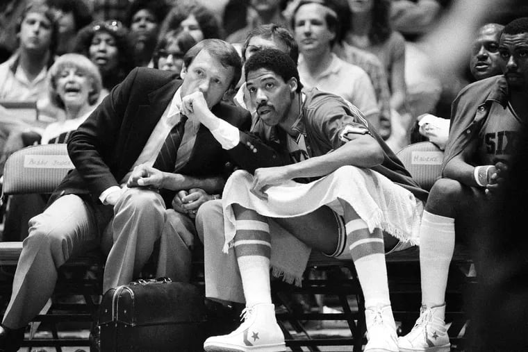 Sixers coach Billy Cunningham (left) conferring with Julius Erving during the fourth quarter of an NBA playoff game on June 7, 1982.
