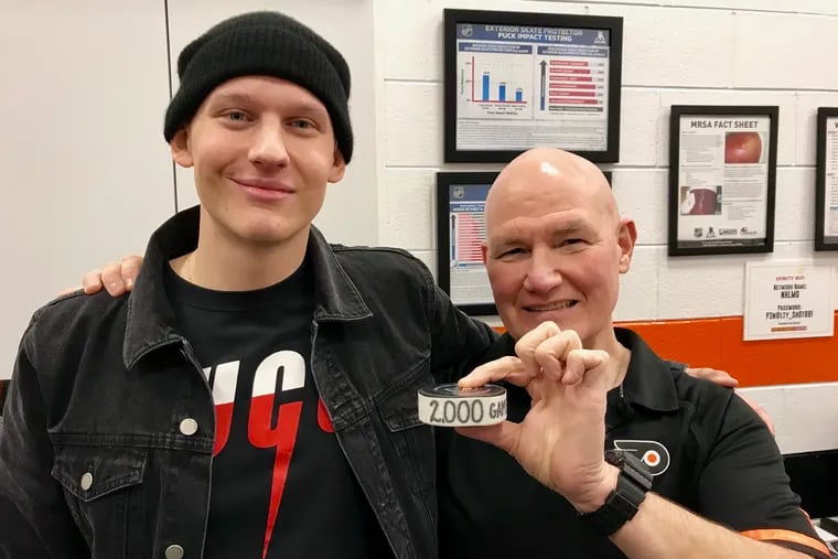 Former Flyer Oskar Lindblom (left) poses with Jim McCrossin, after he was saluted for his 2,000th professional game in 2000.