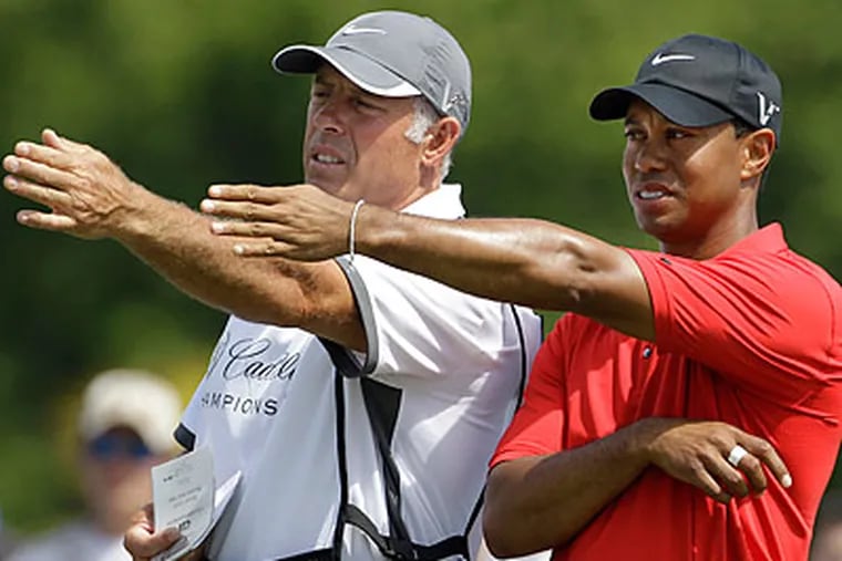 Steve Williams (left) worked as Tiger Woods' caddie for 12 years. (Lynne Sladky/AP file photo)
