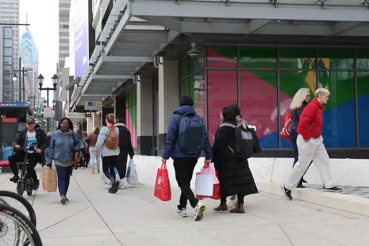 Shoppers walk by the Fashion District near Ninth and Market Streets in Philadelphia on Black Friday, Nov. 24, 2023. Four new stores opened there late this fall.