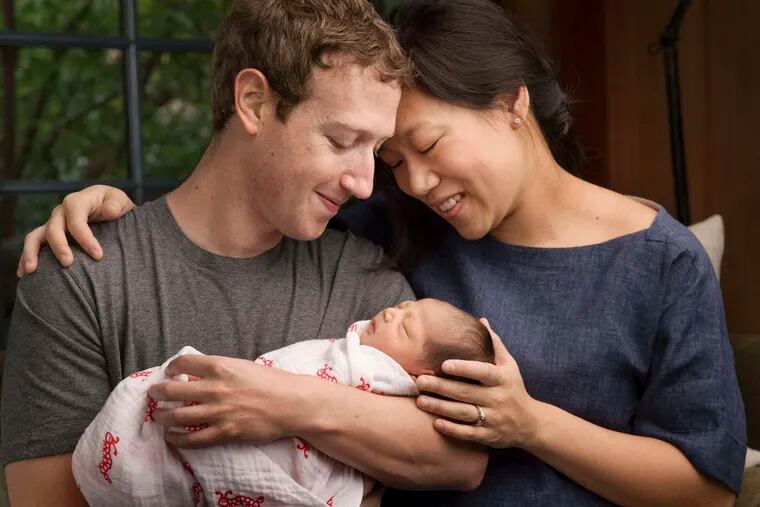 Maxima &quot;Max&quot; Chan Zuckerberg is held by her parents, Mark Zuckerberg and Priscilla Chan, in a photo provided by the Facebook founder.