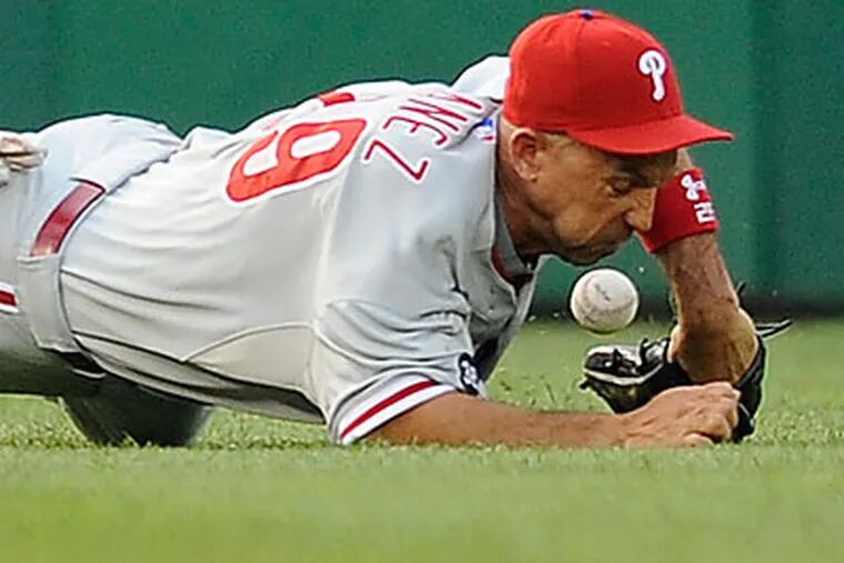 Raul Ibanez injured his wrist diving for a fly ball in the first inning Saturday night. (Nick Wass/AP)