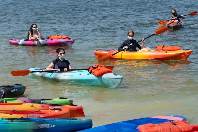 Maggie Lutz, front center, Izzy Carreon, back left, Maggie OÕDonnell, back right, Liam OÕDonnell, far back right, rent Kayaks at Marsh Creek, in Downingtown, PA, on Tuesday.