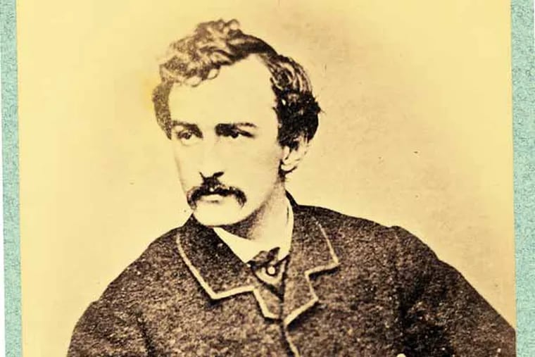 In this photo provided by the Library of Congress, John Wilkes Booth, holding a cane, shown sometime between 1860 and 1865, location unknown. Booth assassinated President Abraham Lincoln at Ford's Theatre, Washington D.C., on April 14, 1865. (AP Photo/Library of Congress)