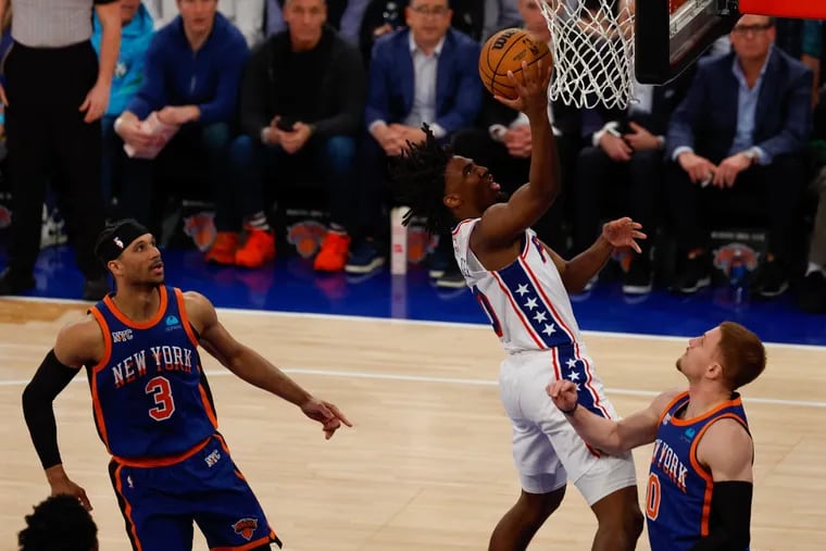 Sixers Tyrese Maxey scores against Knicks Donte DiVincenzo and Josh Hart, left, during Game 5 in New York on April 30.