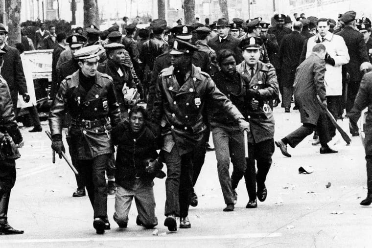 During the Board of Education student protest on Nov. 17, 1967, police escort two demonstrators from the scene.
