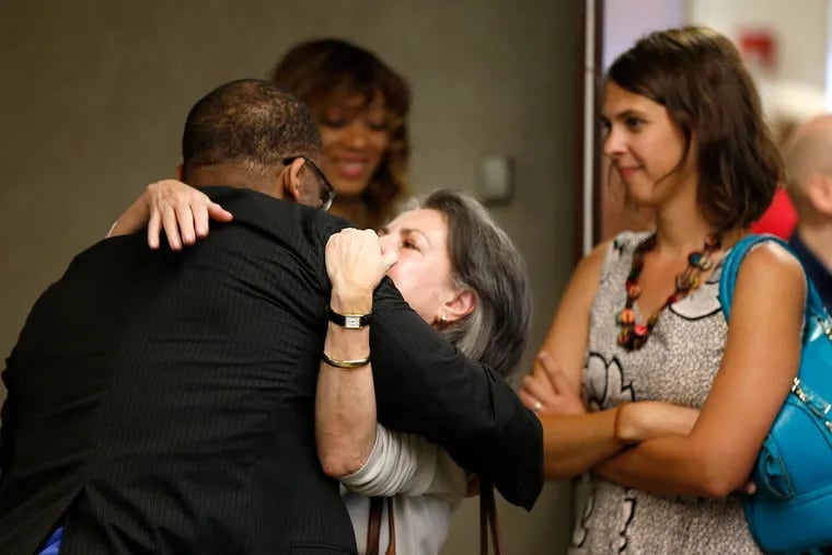 Anthony Wright gets a hug from Grace Greco, the jury forewoman at his retrial in a 1991 rape and murder. DNA led to someone else. “The evidence was so compelling for Tony that there really could have been no other verdict” than not guilty, she said. They were at a news conference Wednesday at the Schnader Harrison law offices.