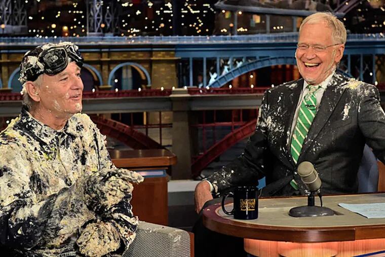Bill Murray, the first guest on David Letterman's very first show, jumped out of a cake Tuesday night to say farewell. (JOHN PAUL FILO / CBS VIA AP)