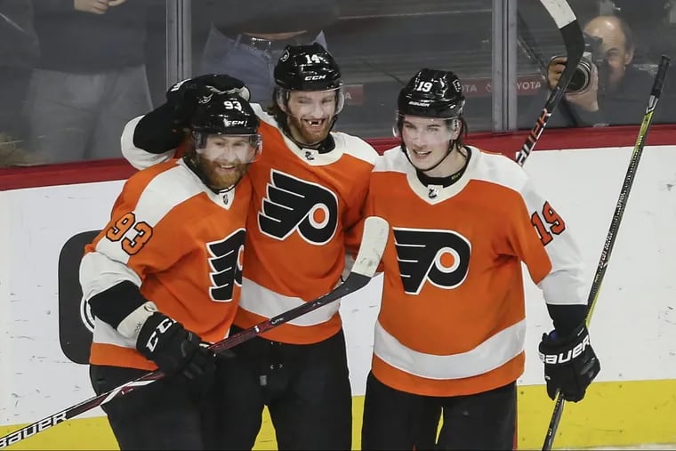 Jake Voracek (left) celebrating his game-tying goal against the Canadiens on Feb. 20 with teammates Sean Couturier and Nolan Patrick (19). Voracek fired in the game-winner a short time later in overtime.