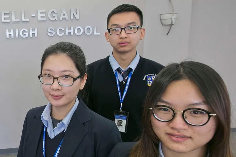 Chinese students (from left) Iris Zhang, 18; Yi Ning, 19; and Yan Cao, 18, attend Conwell-Egan Catholic High School.
