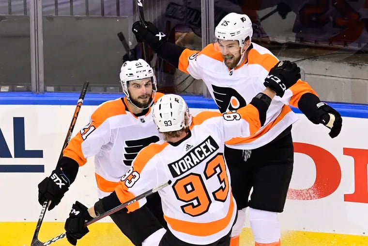 Flyers left winger James van Riemsdyk (25) celebrates his goal against the New York Islanders with Scott Laughton (21) and Jake Voracek (93) during first-period of Game 6.  Will all thre be back next season?