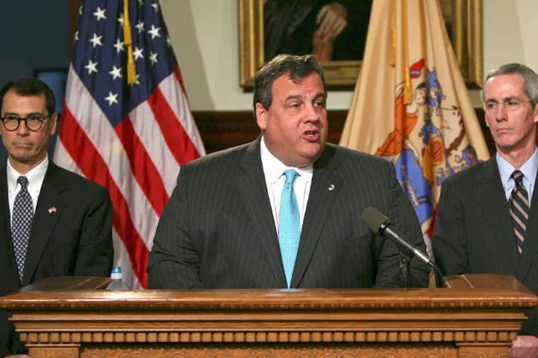 In this photo provided by the New Jersey Governor's Office, New Jersey Governor Chris Christie, center, announces his selection of Judge David Bauman, left, of the Superior Court of New Jersey, Monmouth County, and Robert Hanna, right, President of the Board of Public Utilities, for nomination to the positions of Associate Justice of the New Jersey Supreme Court in Trenton, N.J., Monday, Dec. 10, 2012. Christie said the nominations of Bauman, a Republican, and Hanna, who is unaffiliated with either party though he serves in Christie's administration, represents "a compromise" on Christie's part and a bow to Democrats' concerns about maintaining partisan balance on the court.  (AP Photo/NJ Governor's Office, Tim Larsen)