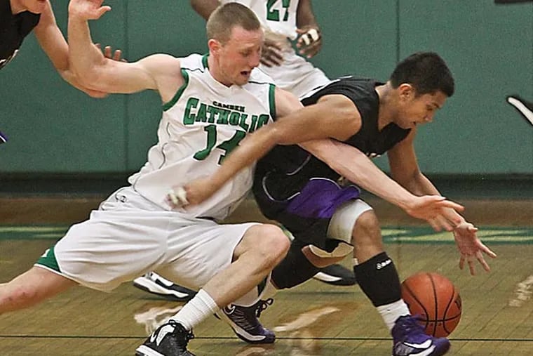 Camden Catholic's Kyle Green tries to steal the ball from Cherry Hill West's Ey Olarte. DAVID M WARREN / Staff Photographer