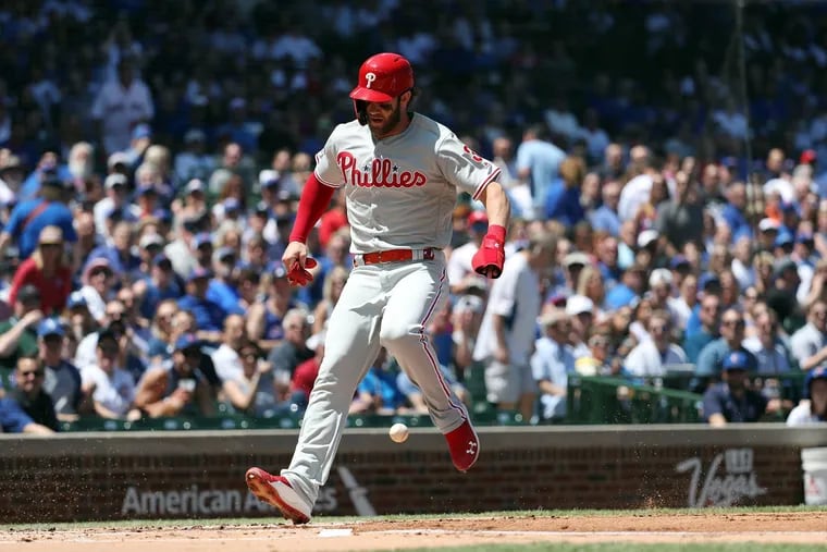 Bryce Harper scoring a first-inning run on a wild pitch by Chicago's Jon Lester on Thursday. The Phillies beat the Cubs, 9-7, in the finale of a four-game series.