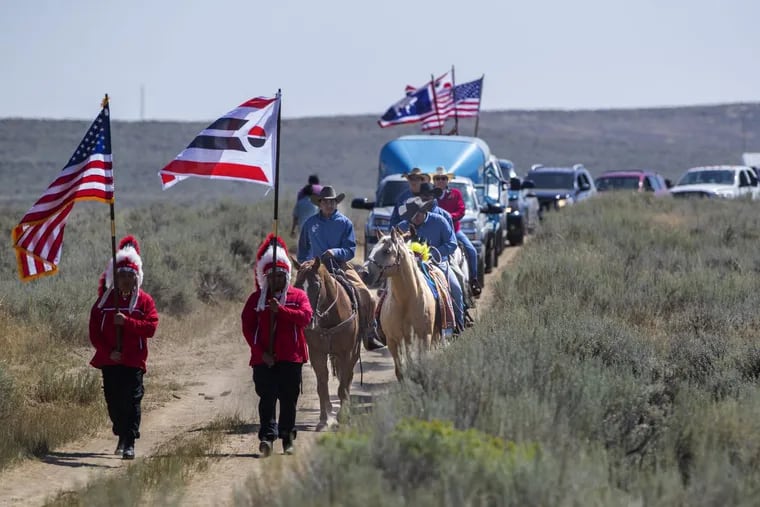 Flag bearers lead a procession to the reburial of Little Chief  at the Wind River Indian Reservation in Wyoming.