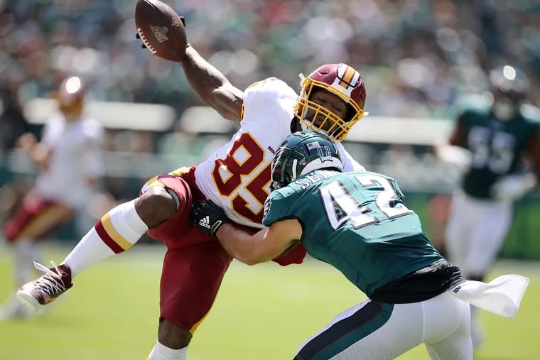 Eagles safety Andrew Sendejo (42) can't stop Redskins tight end Vernon Davis (85) as Davis runs for a touchdown in the first quarter on Sept. 8.