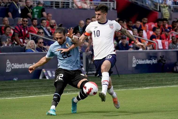 Uruguay's Martin Caceres (left) and the U.S.' Christian Pulisic (10) chase the ball during the first half.