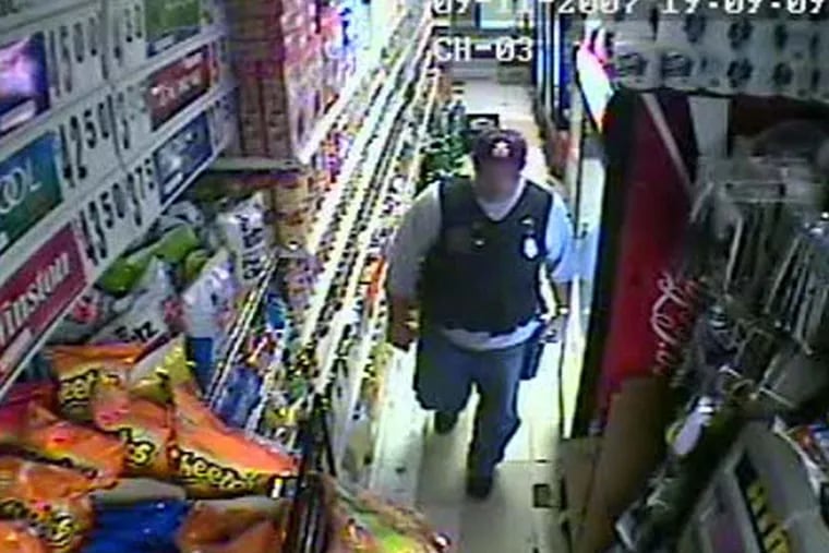 Surveillance video still of then Philadelphia Police Sergeant Joseph Bologna, now a lieutenant, during a raid of a West Oak Lane grocery store on September 11, 2007.